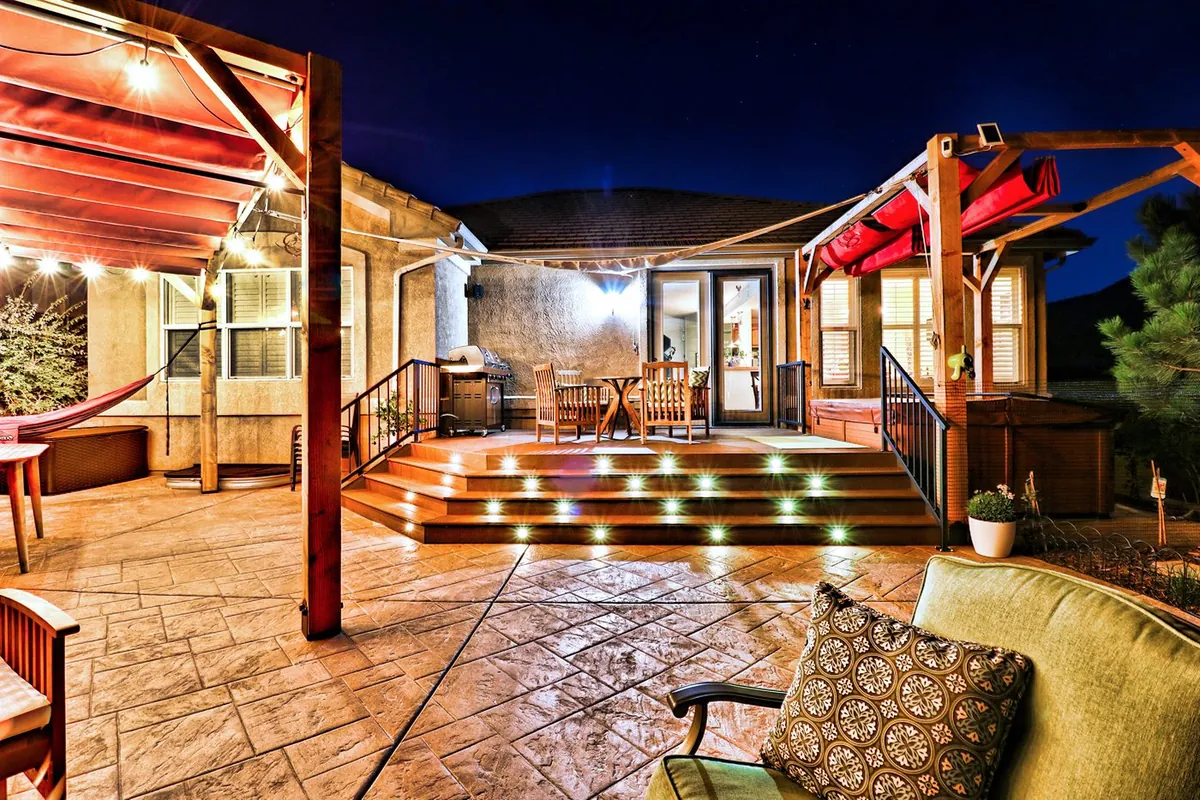 A deck and pergola lit at dusk