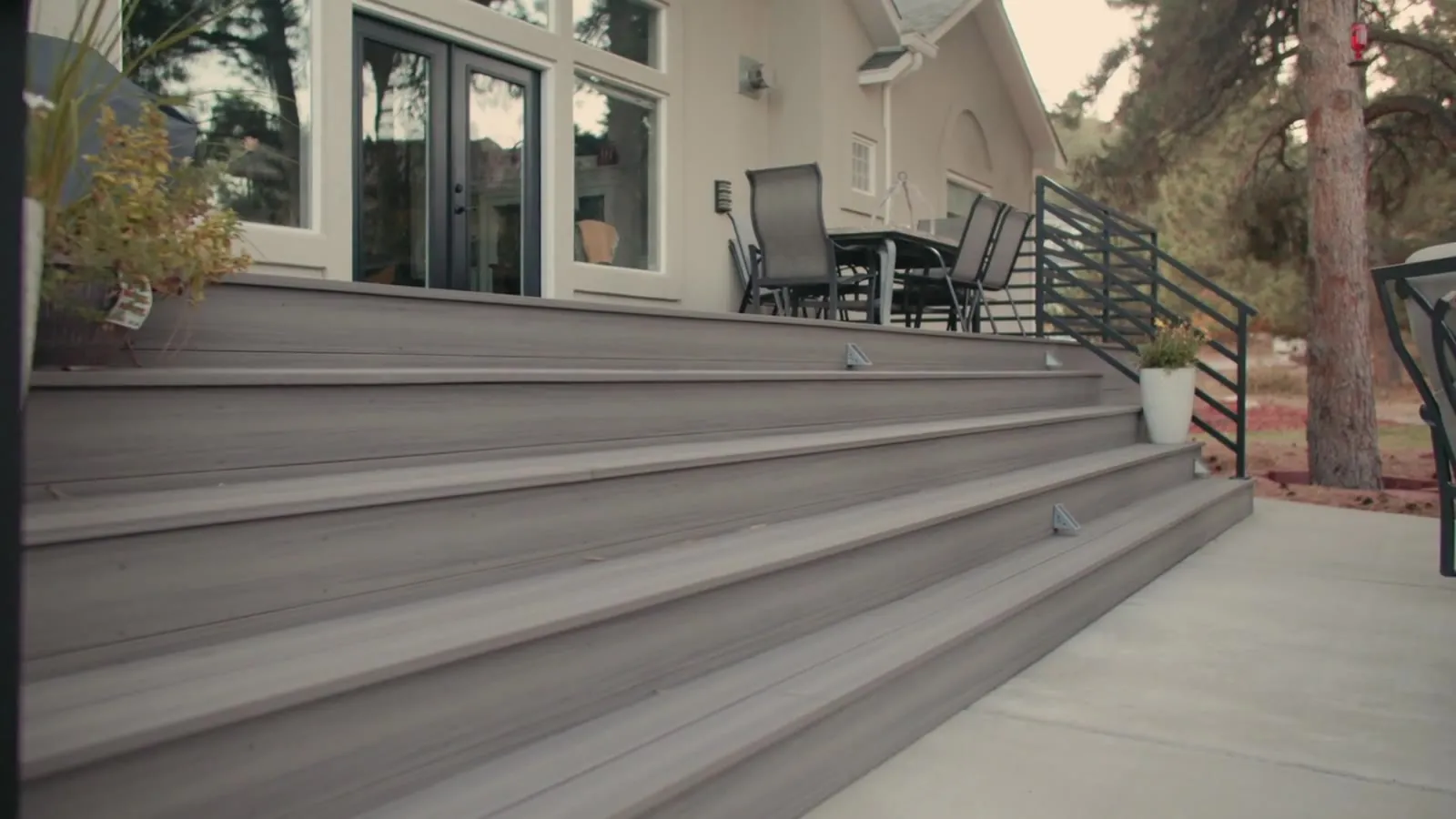 A Stoddard deck and railing running the full width of the house